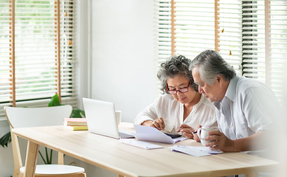 Two people sitting at a laptop