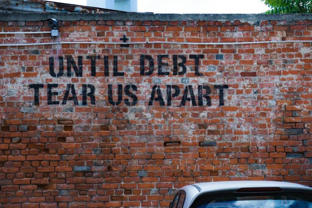 until debt tear us apart brick wall vandal