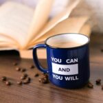 blue and white mug on brown wooden table