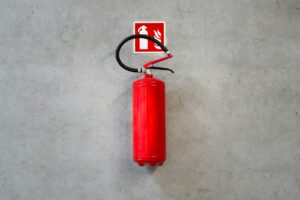 a red fire extinguisher hanging on a wall